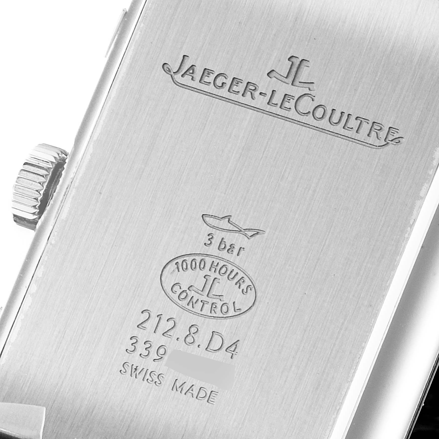 The image shows the back of a Jaeger-LeCoultre Reverso watch, highlighting the case back with engravings and the crown on the side.