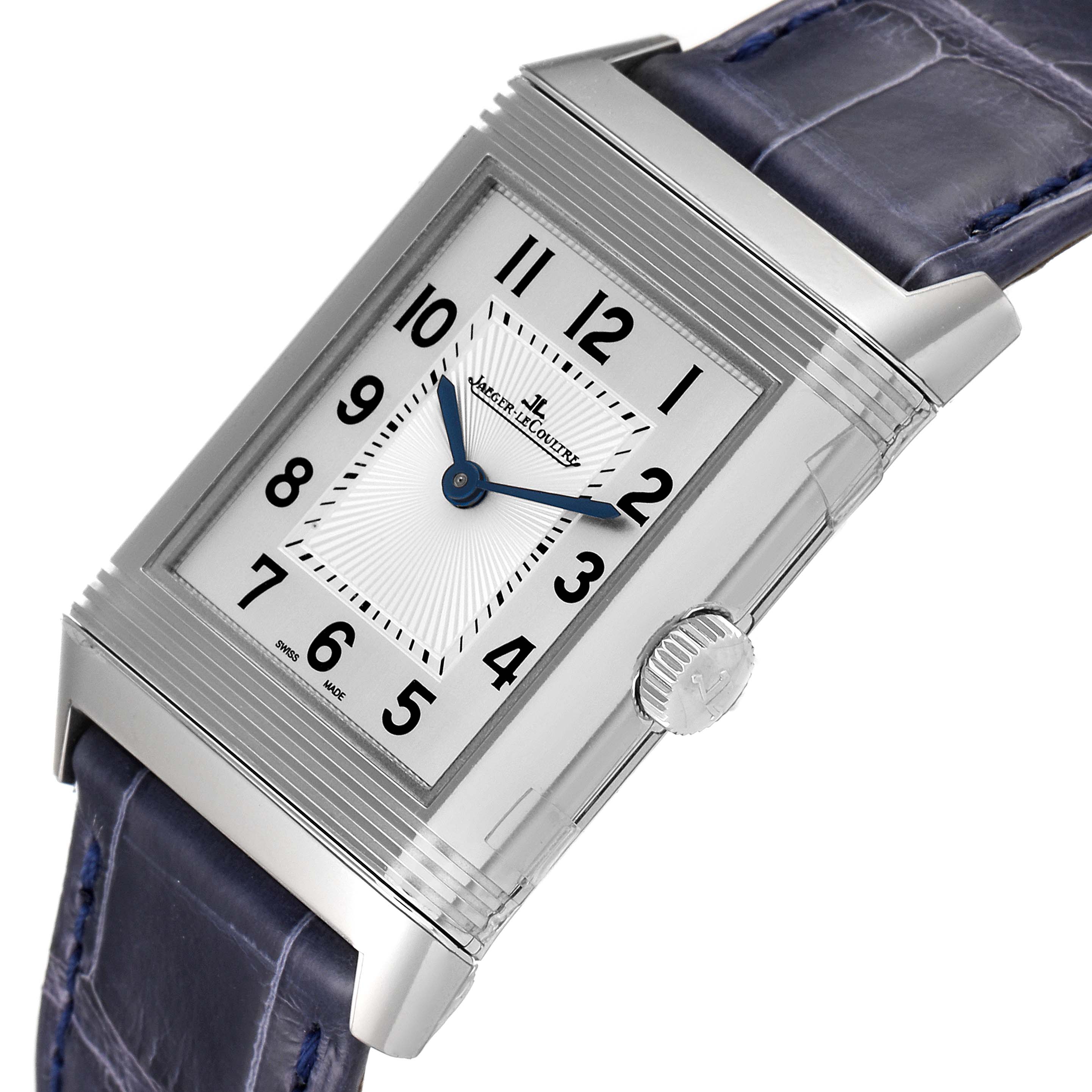 The Jaeger-LeCoultre Reverso watch is shown at a slight angle, displaying its face, crown, and part of the leather strap.