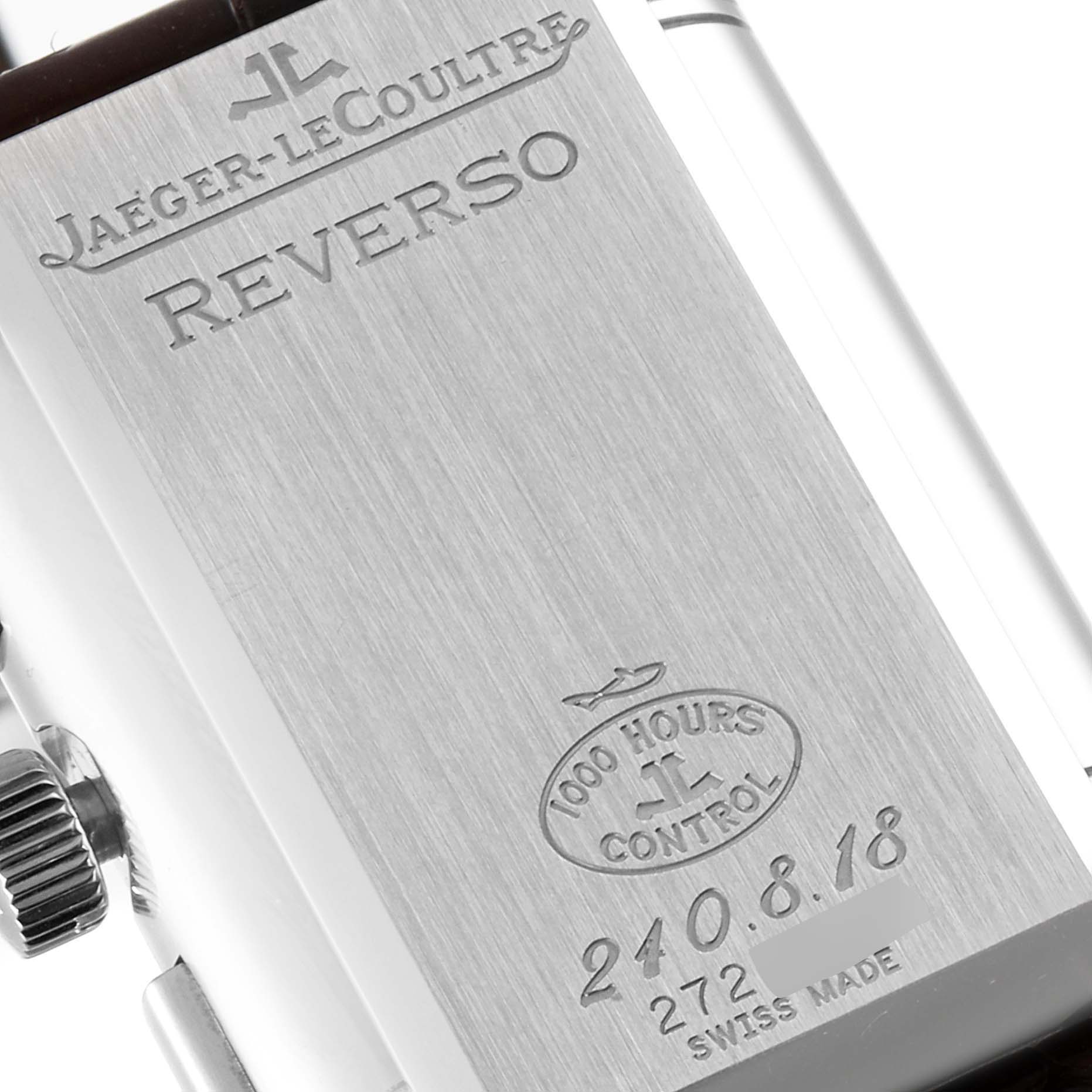 This close-up image shows the back of a Jaeger-LeCoultre Reverso watch, highlighting the engraved branding and model details.
