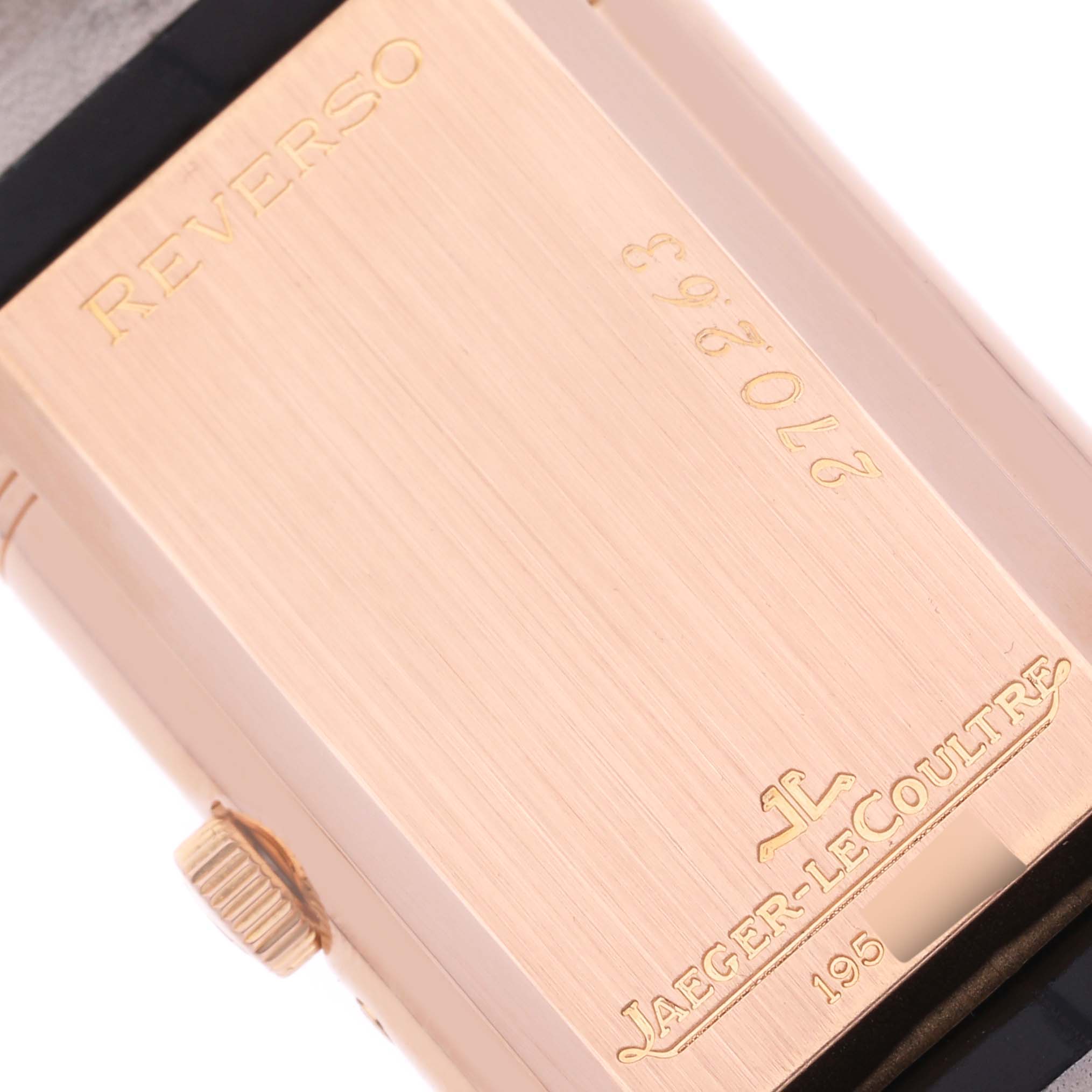 The image shows the reverse side of a Jaeger-LeCoultre Reverso watch, highlighting the case back and crown.