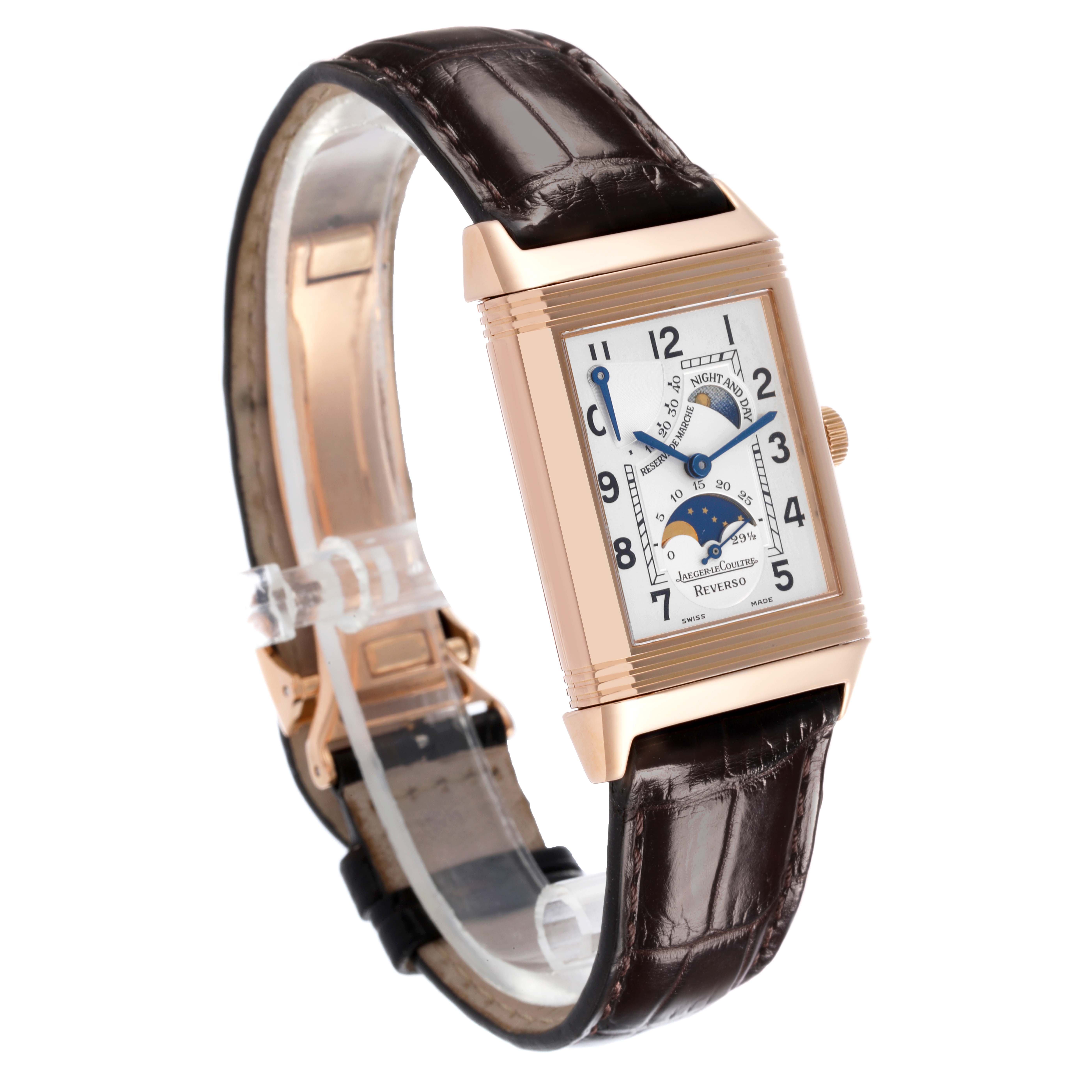 The Jaeger-LeCoultre Reverso watch is shown at a three-quarter angle, highlighting the dial, case, crown, and leather strap.