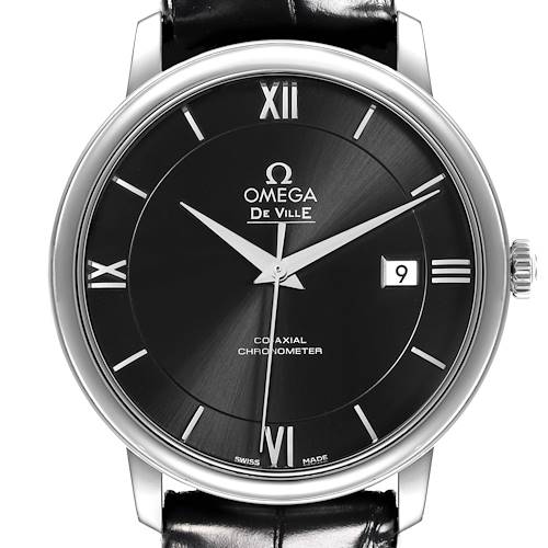 The Omega De Ville watch is shown from a front angle, displaying the dial, Roman numerals, date window, and crown.