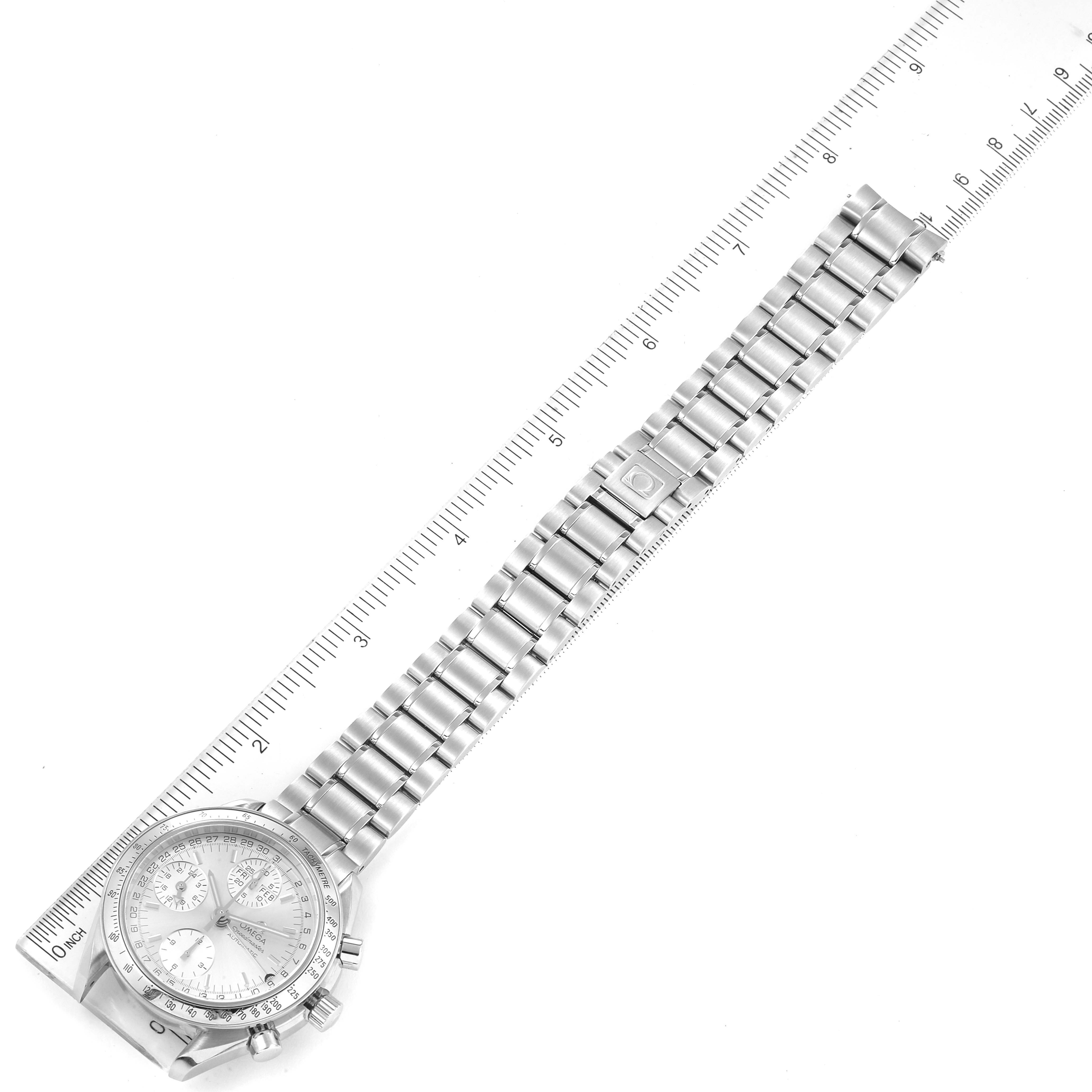 The image shows an Omega Speedmaster 3523.30.00 Men
s Stainless Steel Silver Dial 3523.30.00 Men
s Stainless Steel Silver Dial watch lying flat with a focus on its metal bracelet and a ruler for scale.