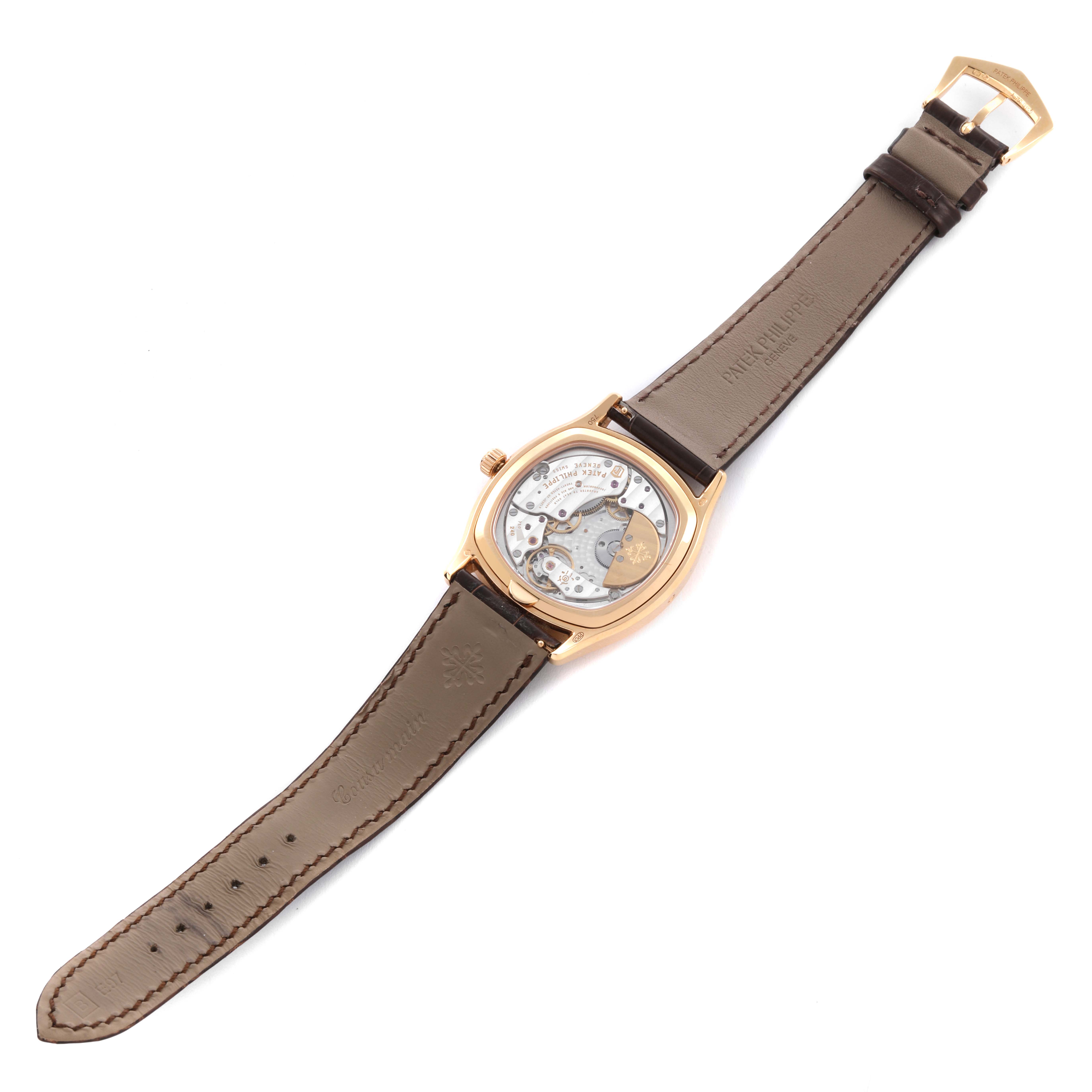 The image shows the back view of the Patek Philippe Complications 5940R - 001 Men's Rose Gold Silver Dial 5940R - 001 Men's Rose Gold Silver Dial model, highlighting the movement and leather strap.