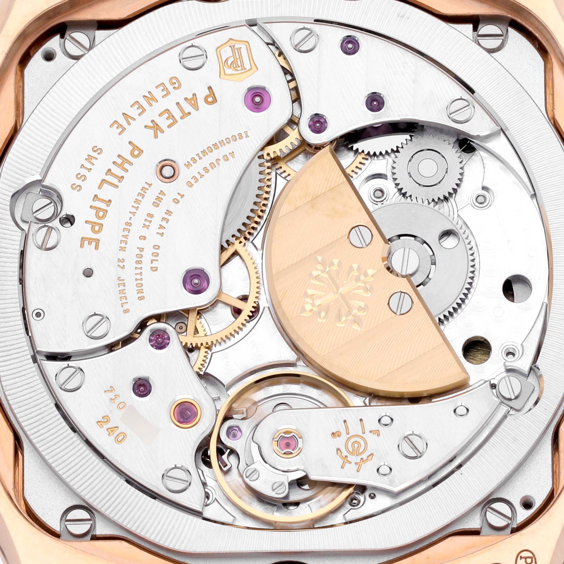 The image shows the back view of a Patek Philippe Complications 5940R - 001 Men's Rose Gold Silver Dial 5940R - 001 Men's Rose Gold Silver Dial watch, focusing on its intricate movement and rotor.