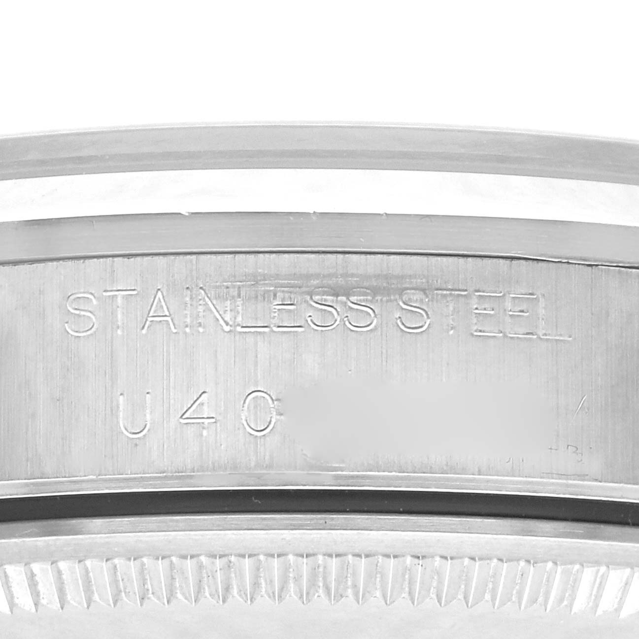 The image shows an angled close-up of the stainless steel inner engraving on the Rolex Air-King 14000 Men's Stainless Steel Blue Dial 14000 Men's Stainless Steel Blue Dial watch bezel.