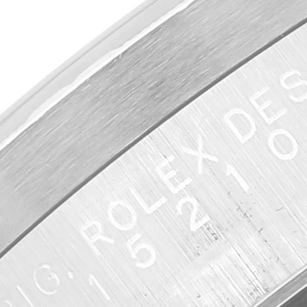 The image shows a close-up of the side of the case for a Rolex Date 15210 Men's Stainless Steel Blue Dial 15210 Men's Stainless Steel Blue Dial model watch, focusing on the engraved text.