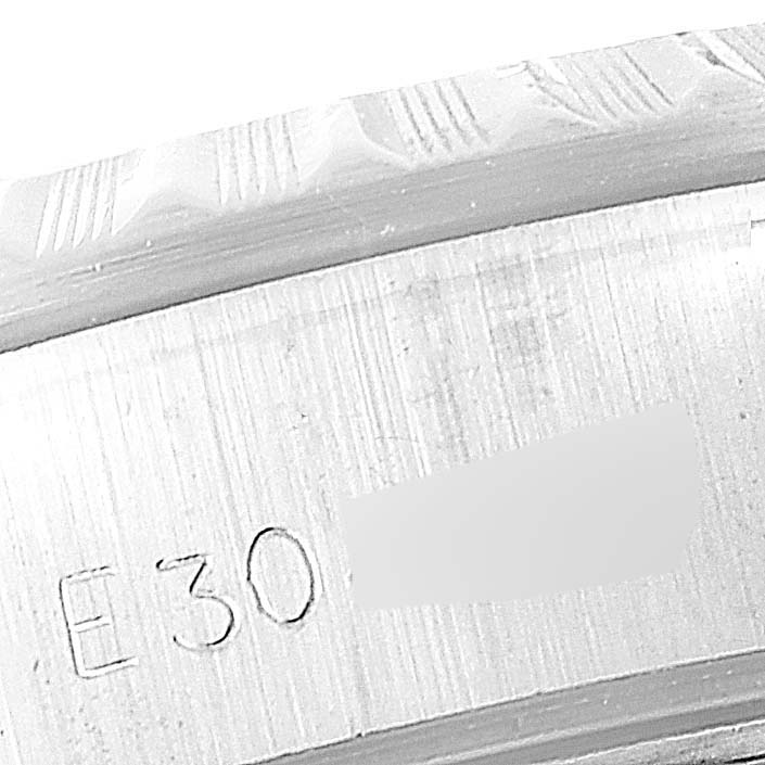 The image shows an engraved edge and part of the fluted bezel of a Rolex Date 69240 Women
s Stainless Steel Silver Dial 69240 Women
s Stainless Steel Silver Dial model watch.