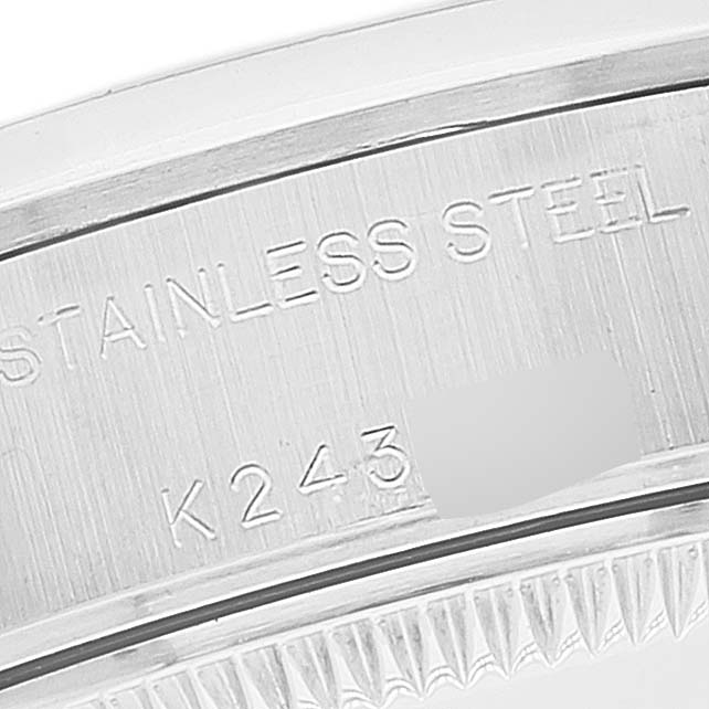 The image shows a close-up of the Rolex Date 79160 Women
s Stainless Steel White Dial 79160 Women
s Stainless Steel White Dial model
s stainless steel case with part of its serial number.