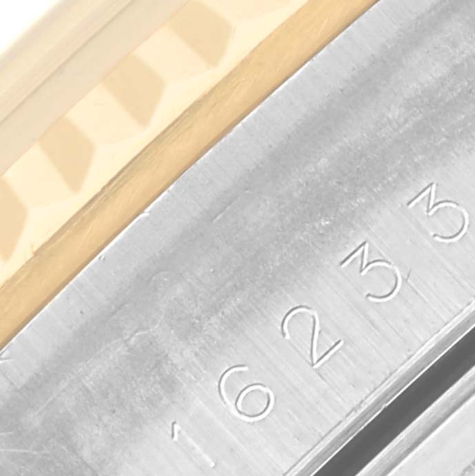 The image shows a close-up of the bezel and engraved edge of a Rolex Datejust 16233 Men's Steel and Gold (two tone) Champagne Dial 16233 Men's Steel and Gold (two tone) Champagne Dial watch.