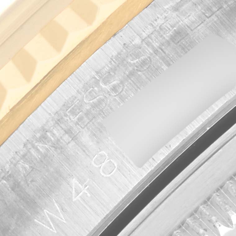 The image shows a close-up of the Rolex Datejust 16233 Men's Steel and Gold (two tone) Champagne Dial 16233 Men's Steel and Gold (two tone) Champagne Dial's bezel and rehaut with part of the gold fluted edge.