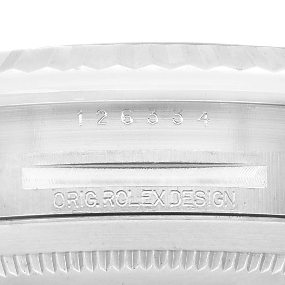 The image shows a close-up of the model number "126334" and "O. RIG. ROLEX DESIGN" on the side of a Rolex Datejust 41 126334 Men
s Stainless Steel Black Dial 126334 Men
s Stainless Steel Black Dial watch case.