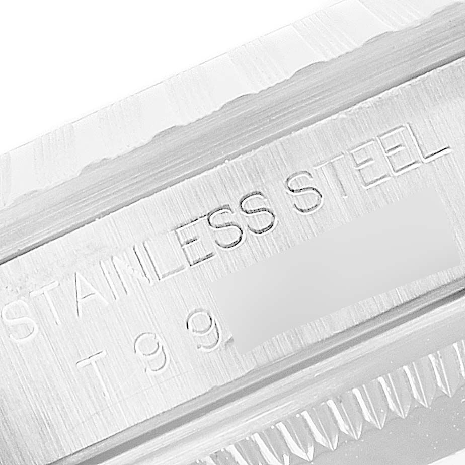 This image shows a close-up of the stainless steel, fluted bezel, and engravings on a Rolex Datejust 16220 Men
s Stainless Steel Silver Dial 16220 Men
s Stainless Steel Silver Dial watch.