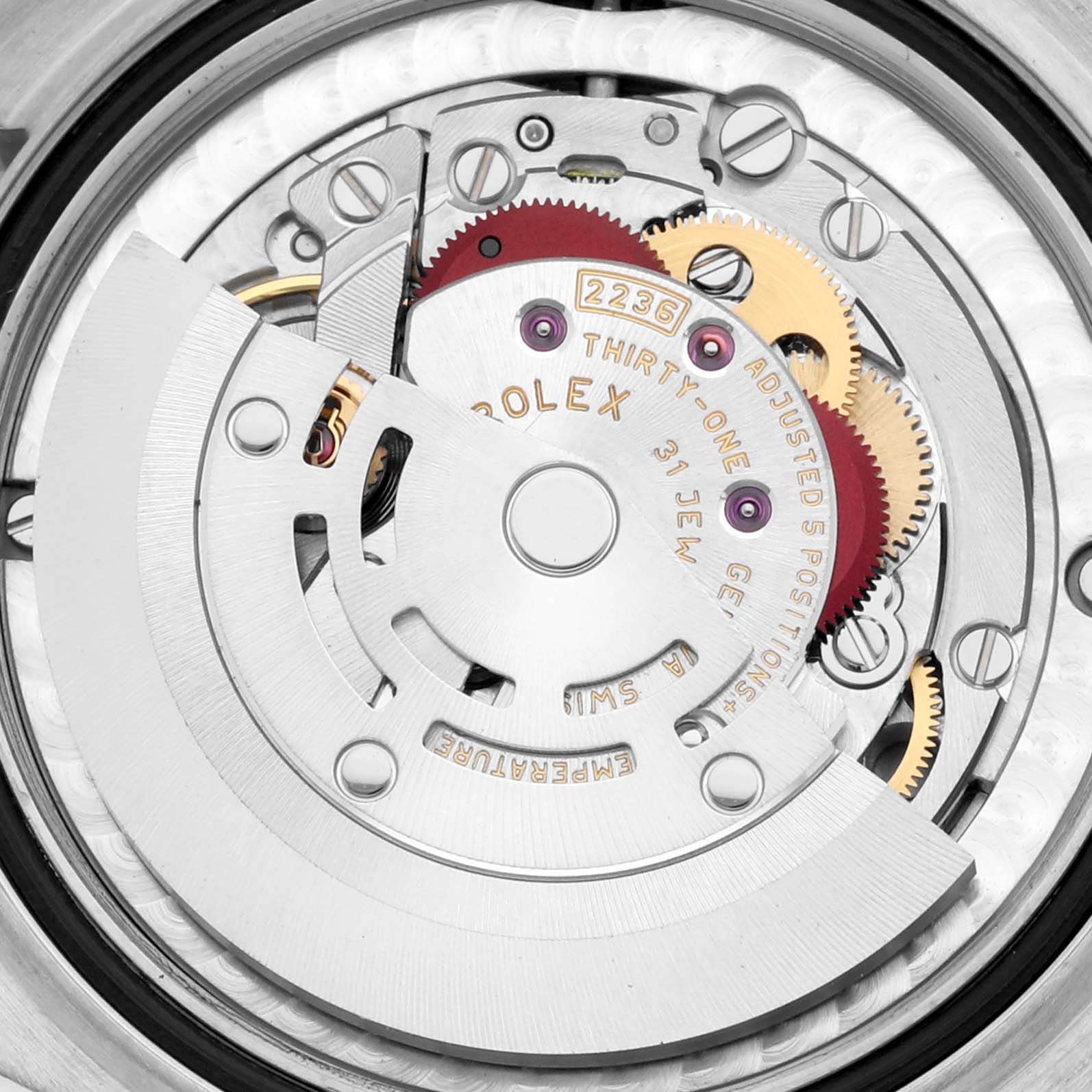 The image shows the movement of a Rolex Mid-Size 278344 Women's White Gold Silver Dial 278344 Women's White Gold Silver Dial watch, focusing on its intricate gears and rotor.