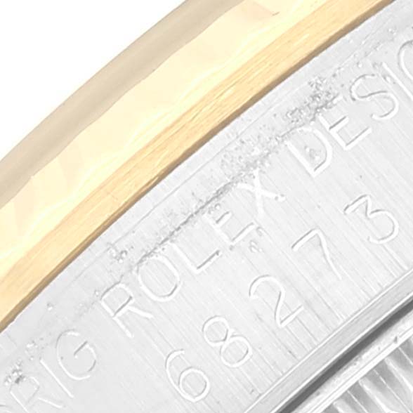This image shows a close-up side view of the casing, bezel, and engraved model number of a Mid-Size Rolex watch.