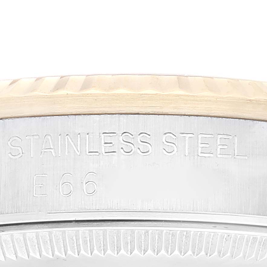 This close-up shows the side of a stainless steel Rolex Mid-Size 68273 Women's Steel and Gold (two tone) Champagne Dial 68273 Women's Steel and Gold (two tone) Champagne Dial watch case, highlighting engravings and part of the bezel.