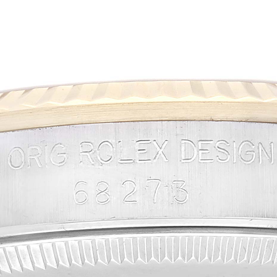 This image shows a close-up of the engraved side of a Rolex Mid-Size 68273 Women's Steel and Gold (two tone) Champagne Dial 68273 Women's Steel and Gold (two tone) Champagne Dial watch case, displaying the design number.