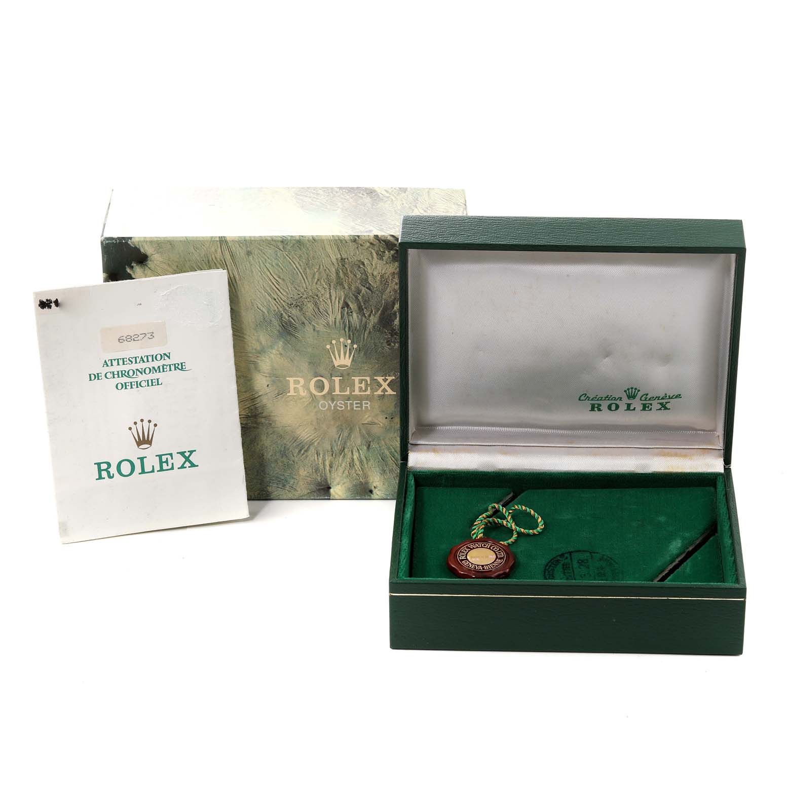 The image shows an open Rolex watch box with a Mid-Size Rolex model, papers, and a seal, viewed from the front.
