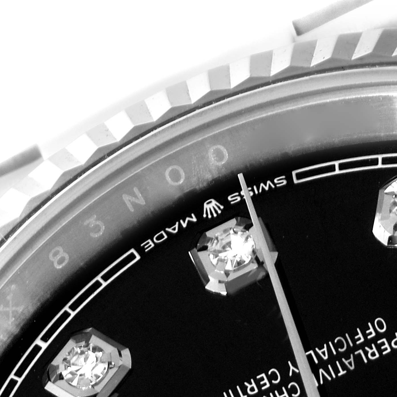 This image shows a close-up of the Rolex Datejust 126234 Men
s Stainless Steel Black Dial 126234 Men
s Stainless Steel Black Dial
s dial, highlighting diamond hour markers, a thin hand, and part of the bezel.