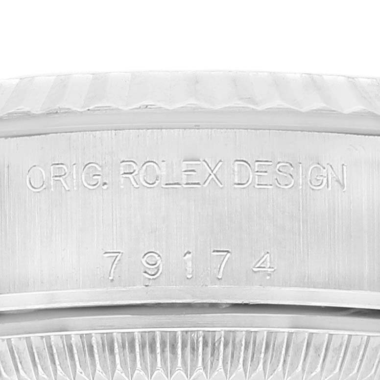 The image shows a close-up of the side engraving on the bezel of a Rolex Datejust 79174 Women's Stainless Steel Silver Dial 79174 Women's Stainless Steel Silver Dial watch.