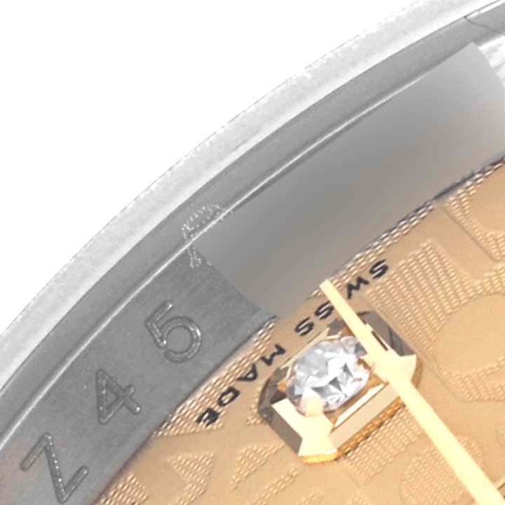 The image shows a close-up of a Rolex Datejust 116233 Men's Steel and Gold (two tone) Champagne Dial 116233 Men's Steel and Gold (two tone) Champagne Dial dial with a diamond marker and partial bezel.