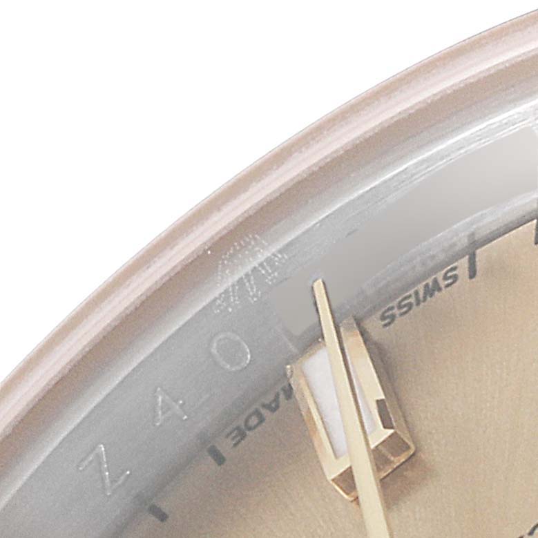 This close-up image shows the dial and gold hand of a Rolex Datejust 179173 Women's Steel and Gold (two tone) Champagne Dial 179173 Women's Steel and Gold (two tone) Champagne Dial watch, focusing on the "Swiss Made" text.