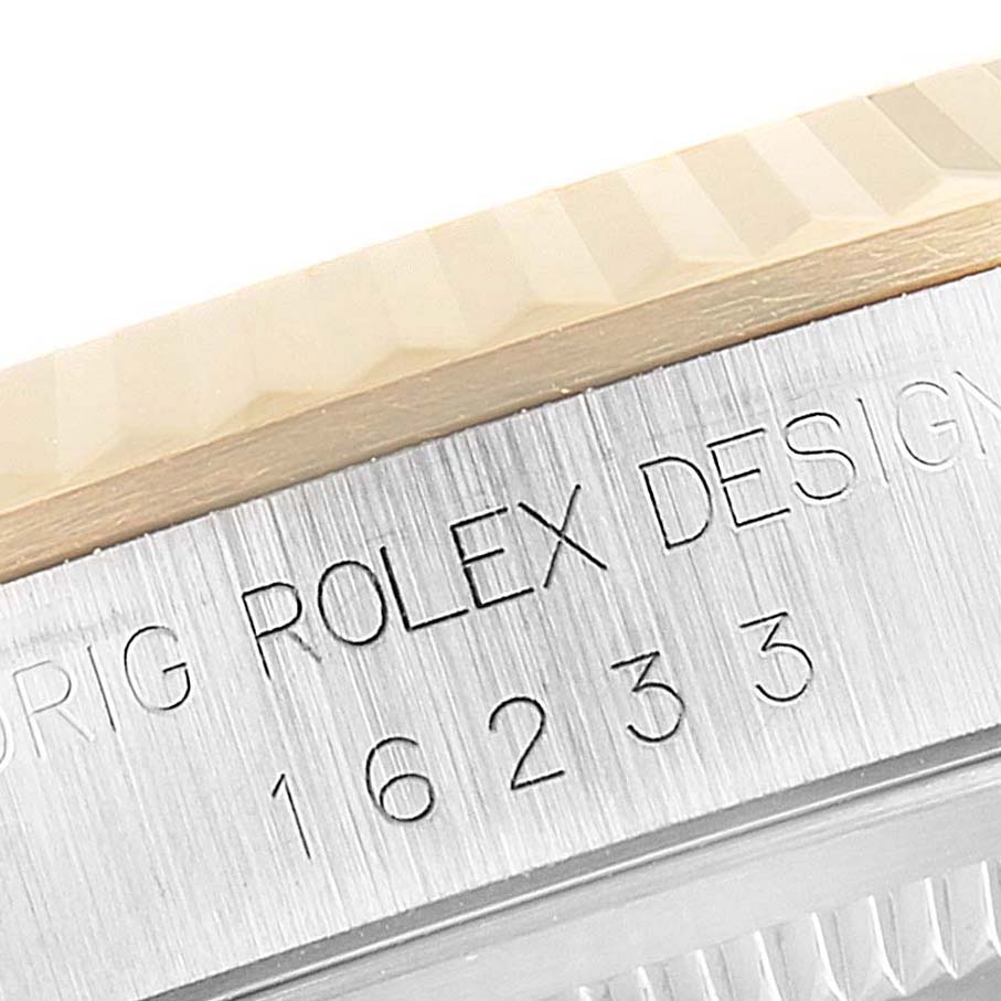 This close-up image shows the side engraving of a Rolex Datejust 16233 Men's Steel and Gold (two tone) Champagne Dial 16233 Men's Steel and Gold (two tone) Champagne Dial watch, with the fluted bezel partially visible.