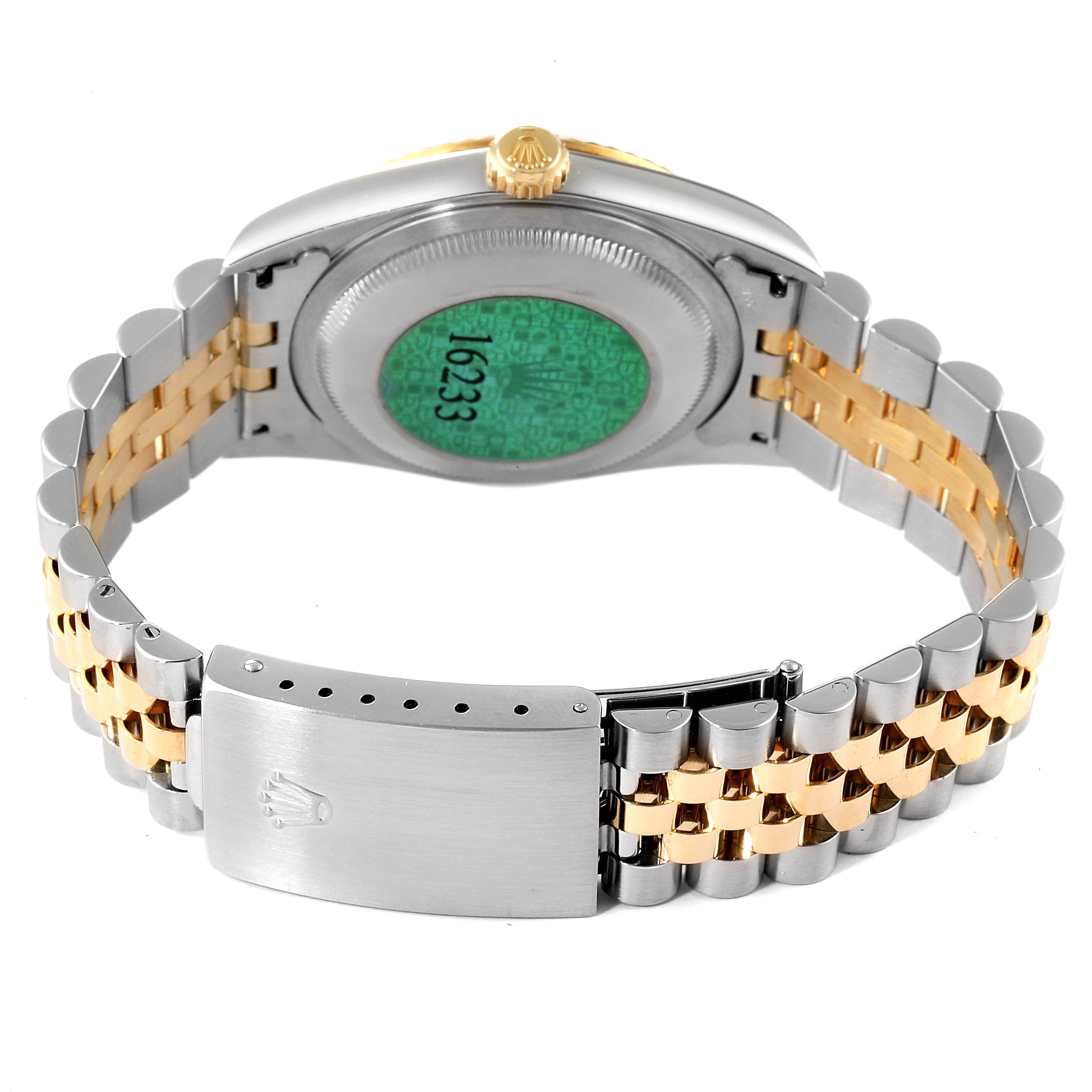 The image shows the back view of a Rolex Datejust 16233 Men's Steel and Gold (two tone) Champagne Dial 16233 Men's Steel and Gold (two tone) Champagne Dial watch, highlighting its two-tone bracelet and partially closed clasp.