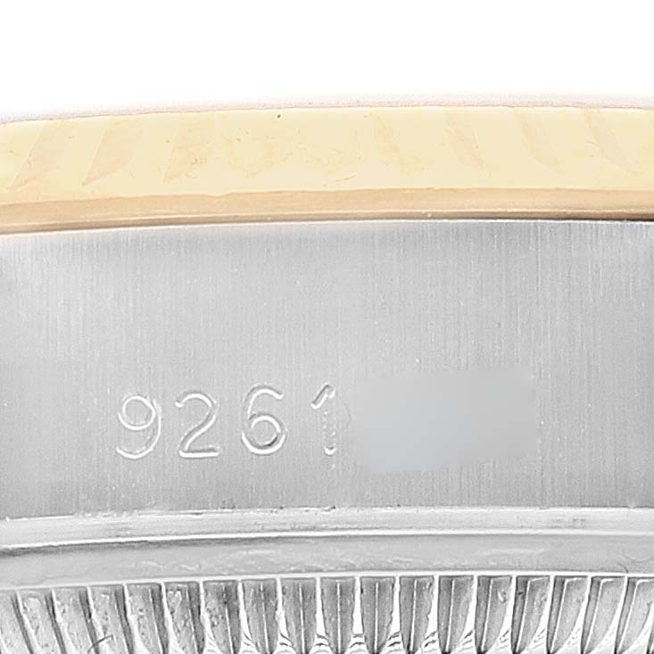 The image shows the side of a Rolex Datejust 69173 Women's Steel and Gold (two tone) Champagne Dial 69173 Women's Steel and Gold (two tone) Champagne Dial watch, highlighting its serial number engraving and part of the bezel.