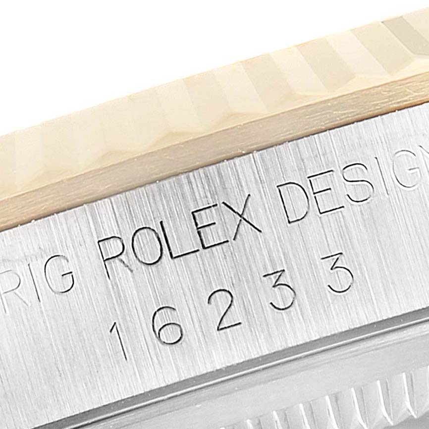 This close-up image shows the engraved bezel and case with the model number 16233 on a Rolex Datejust 16233 Men's Steel and Gold (two tone) Silver Dial 16233 Men's Steel and Gold (two tone) Silver Dial watch.