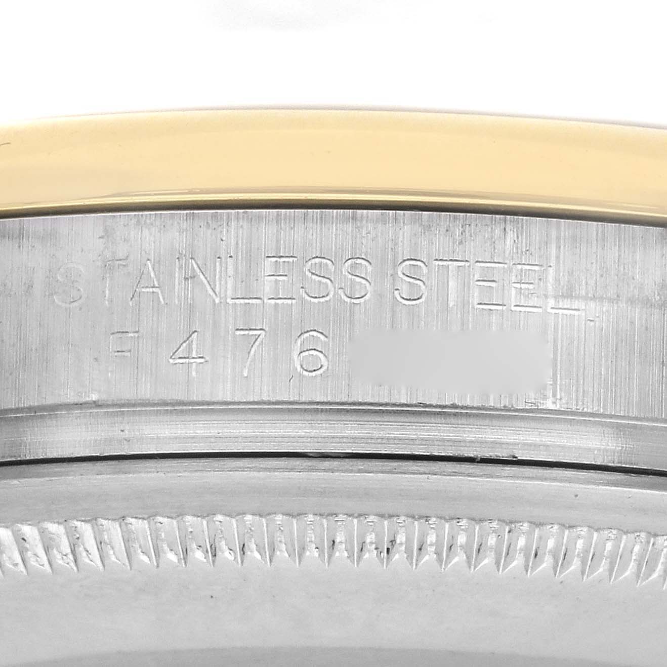The image shows a close-up of the stainless steel case of a Rolex Datejust 116203 Men's Steel and Gold (two tone) Black Dial 116203 Men's Steel and Gold (two tone) Black Dial, with part of the bezel and engraved serial number visible.