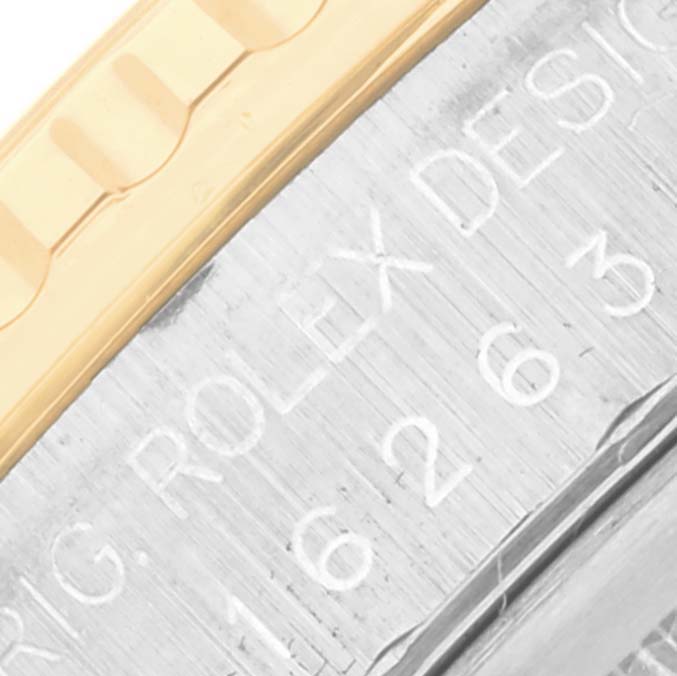 The image shows a close-up of the Rolex Datejust 16263 Men
s Steel and Gold (two tone) Champagne Dial 16263 Men
s Steel and Gold (two tone) Champagne Dial
s bezel and case markings.