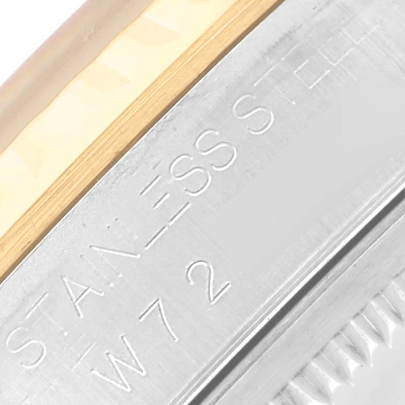 The image shows a close-up of the side of the bezel and case with engravings on the Rolex Datejust 16233 Men's Steel and Gold (two tone) Blue Dial 16233 Men's Steel and Gold (two tone) Blue Dial.