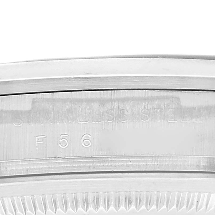 This image shows a close-up of the side engraving on the bezel of the Rolex Explorer 114270 Men
s Stainless Steel Black Dial 114270 Men
s Stainless Steel Black Dial watch, highlighting "STAINLESS STEEL" and part of a serial or model number.