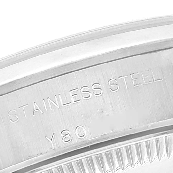 This image shows a close-up of the engraved text "STAINLESS STEEL" on the back case of a Rolex Oyster Perpetual 76080 Women's Stainless Steel Black Dial 76080 Women's Stainless Steel Black Dial watch.