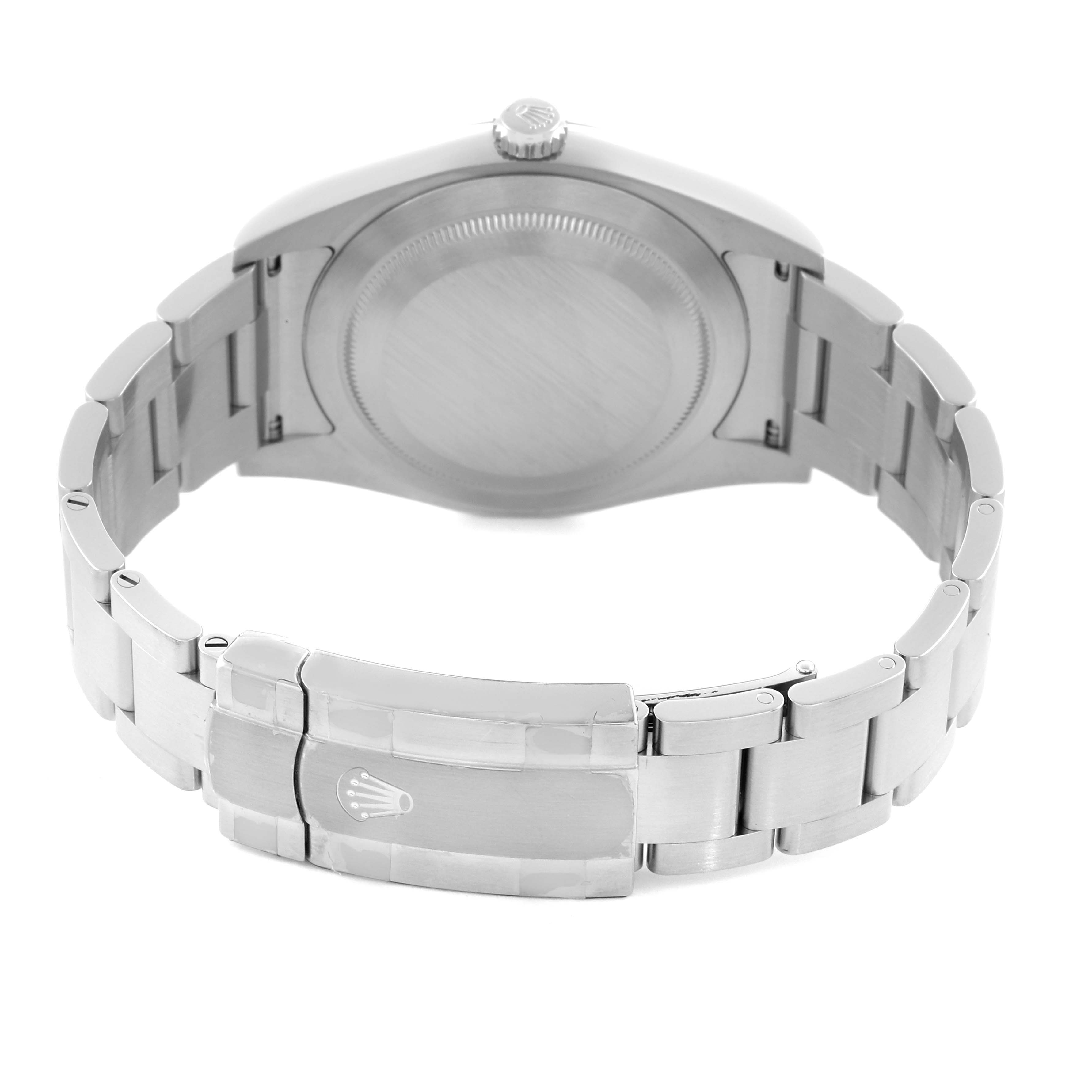 The image shows the back view of a Rolex Oyster Perpetual 114300 Men's Stainless Steel Blue Dial 114300 Men's Stainless Steel Blue Dial watch with its bracelet and clasp visible.