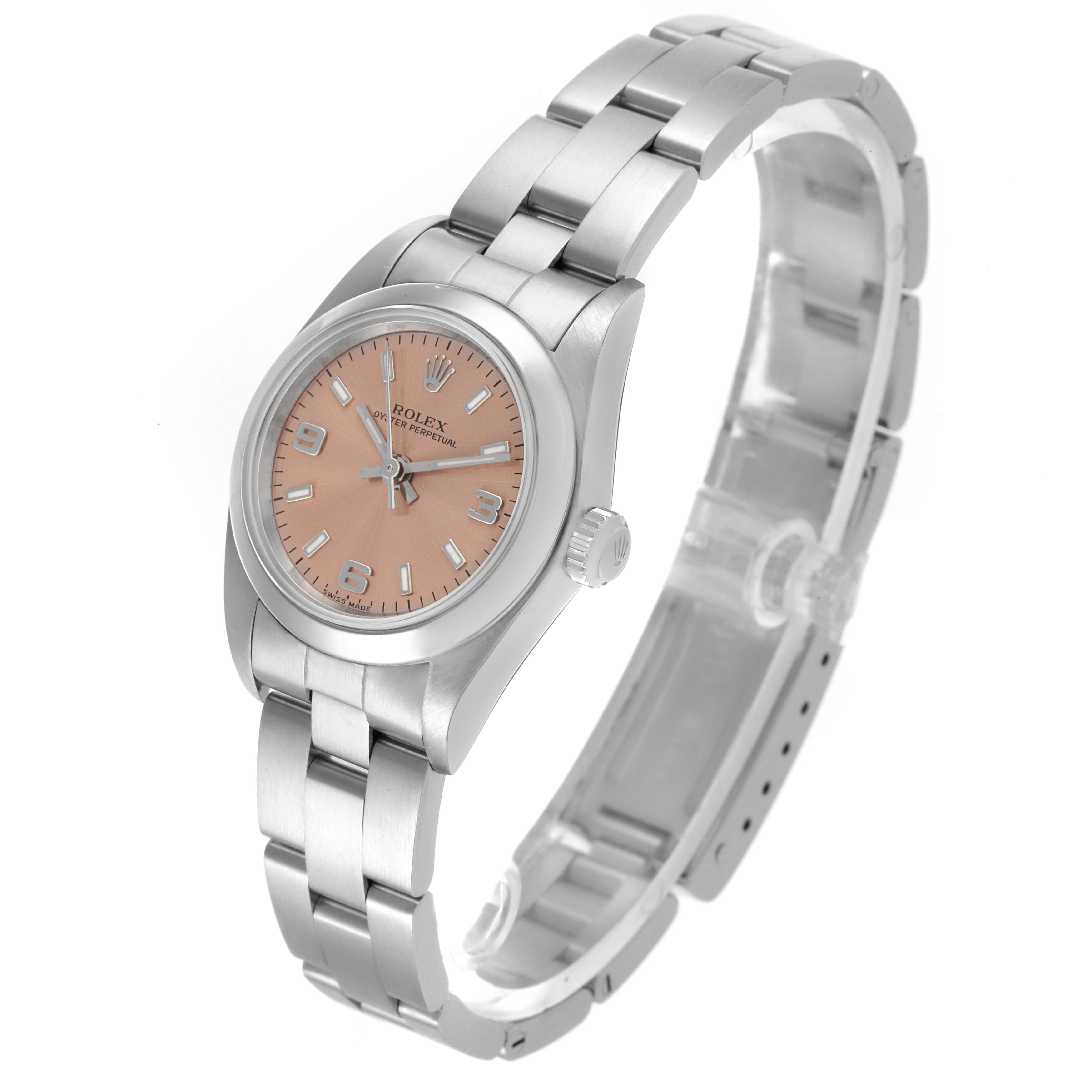 The Rolex Oyster Perpetual 76080 Women's Stainless Steel Brown Dial 76080 Women's Stainless Steel Brown Dial watch is shown at a three-quarter angle, displaying the face, bezel, and bracelet.