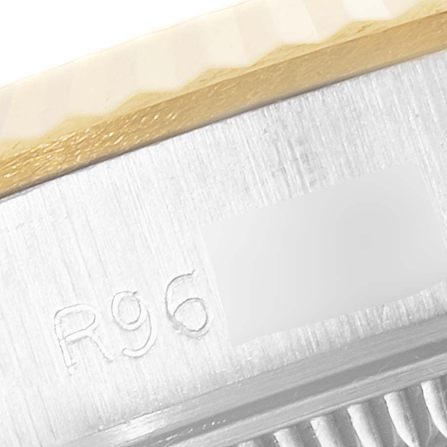 This close-up image shows the side engraving and part of the bezel of a Rolex Oyster Perpetual 67193 Women
s Steel and Gold (two tone) Champagne Dial 67193 Women
s Steel and Gold (two tone) Champagne Dial watch.