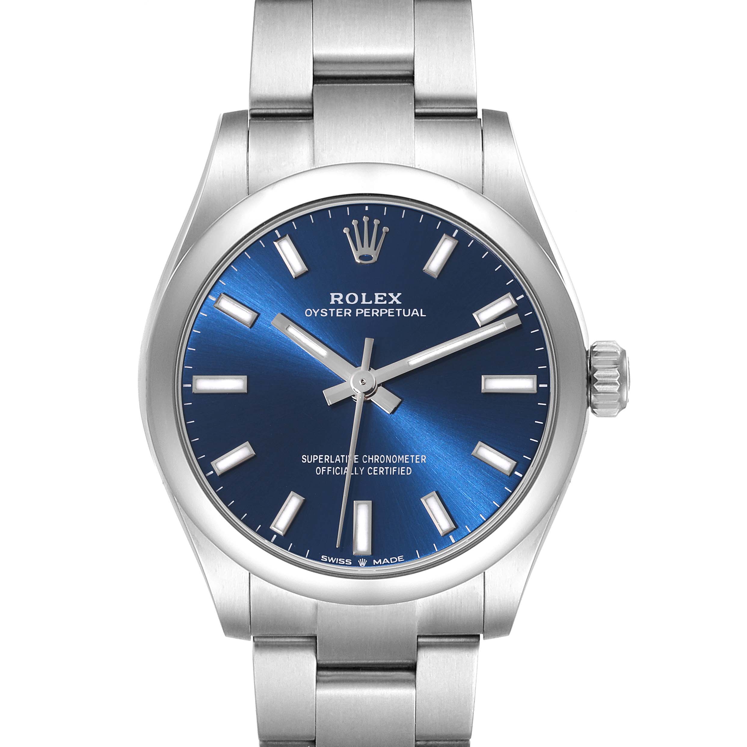 The image shows a front view of a Rolex Oyster Perpetual Mid-Size watch with a blue dial and stainless steel bracelet.
