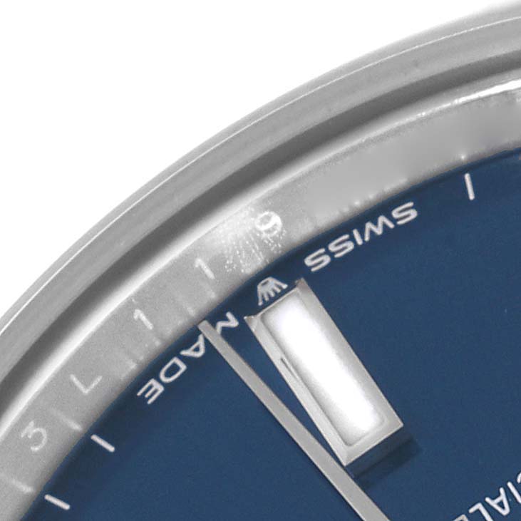 The image shows a close-up of the dial and bezel of a Rolex Mid-Size 277200 Women's Stainless Steel Blue Dial 277200 Women's Stainless Steel Blue Dial model watch, highlighting the "Swiss Made" and minute markers.