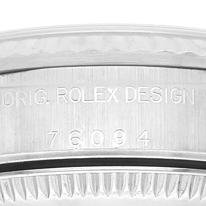 This image shows the side engraving on the case of a Rolex Oyster Perpetual 76094 Women's Stainless Steel Black Dial 76094 Women's Stainless Steel Black Dial model 76094 with "Orig. Rolex Design" text.