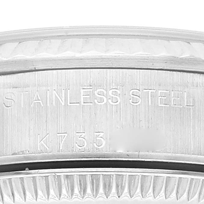 This close-up image of a Rolex Oyster Perpetual 76094 Women's Stainless Steel Black Dial 76094 Women's Stainless Steel Black Dial watch shows the stainless steel case back with engraved details.