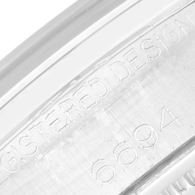 This close-up image shows the engraved serial number and text on the inner case of the Rolex Vintage Collection 6694 Men's Stainless Steel Silver Dial 6694 Men's Stainless Steel Silver Dial model watch.