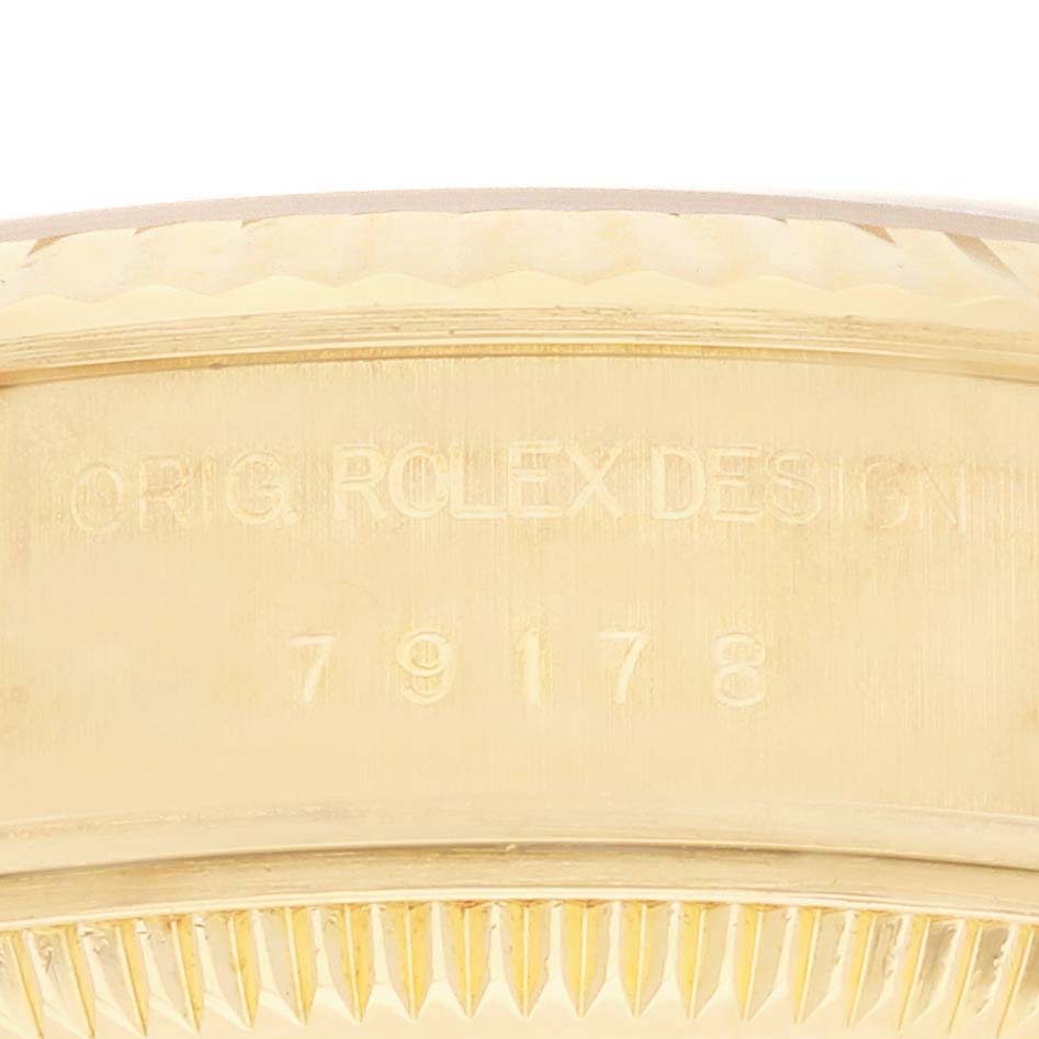 The image shows a close-up of the side of the Rolex President 79178 Women's Yellow Gold Champagne Dial 79178 Women's Yellow Gold Champagne Dial watch, highlighting the engraved design and model number.