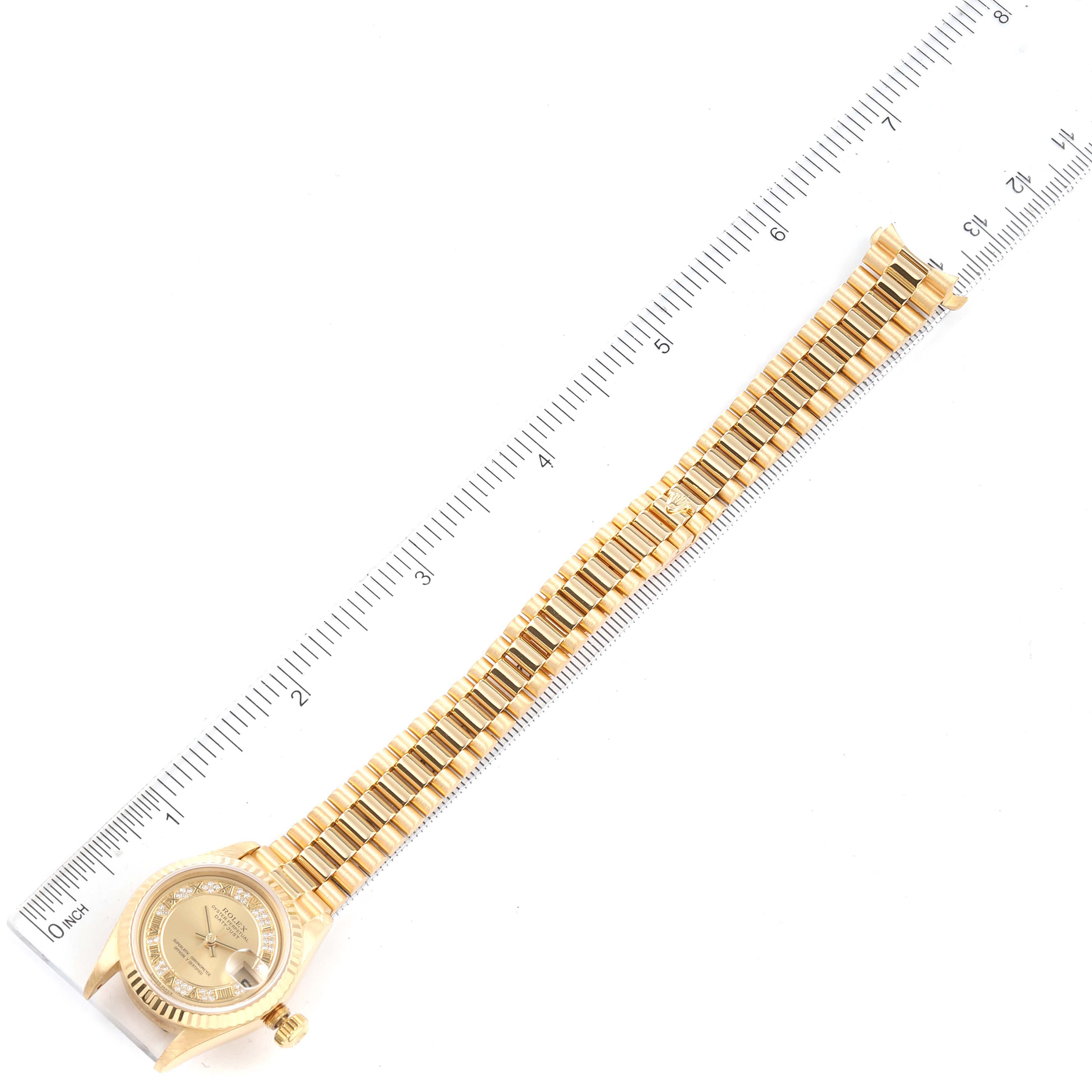 The image shows the Rolex President 79178 Women's Yellow Gold Champagne Dial 79178 Women's Yellow Gold Champagne Dial model watch laid flat, displaying the full band and face next to a measuring ruler.