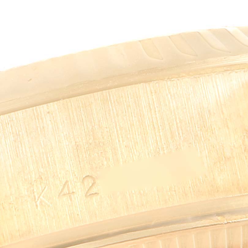 This close-up image shows part of the case edge with engravings on a Rolex President 79178 Women's Yellow Gold Champagne Dial 79178 Women's Yellow Gold Champagne Dial model watch.