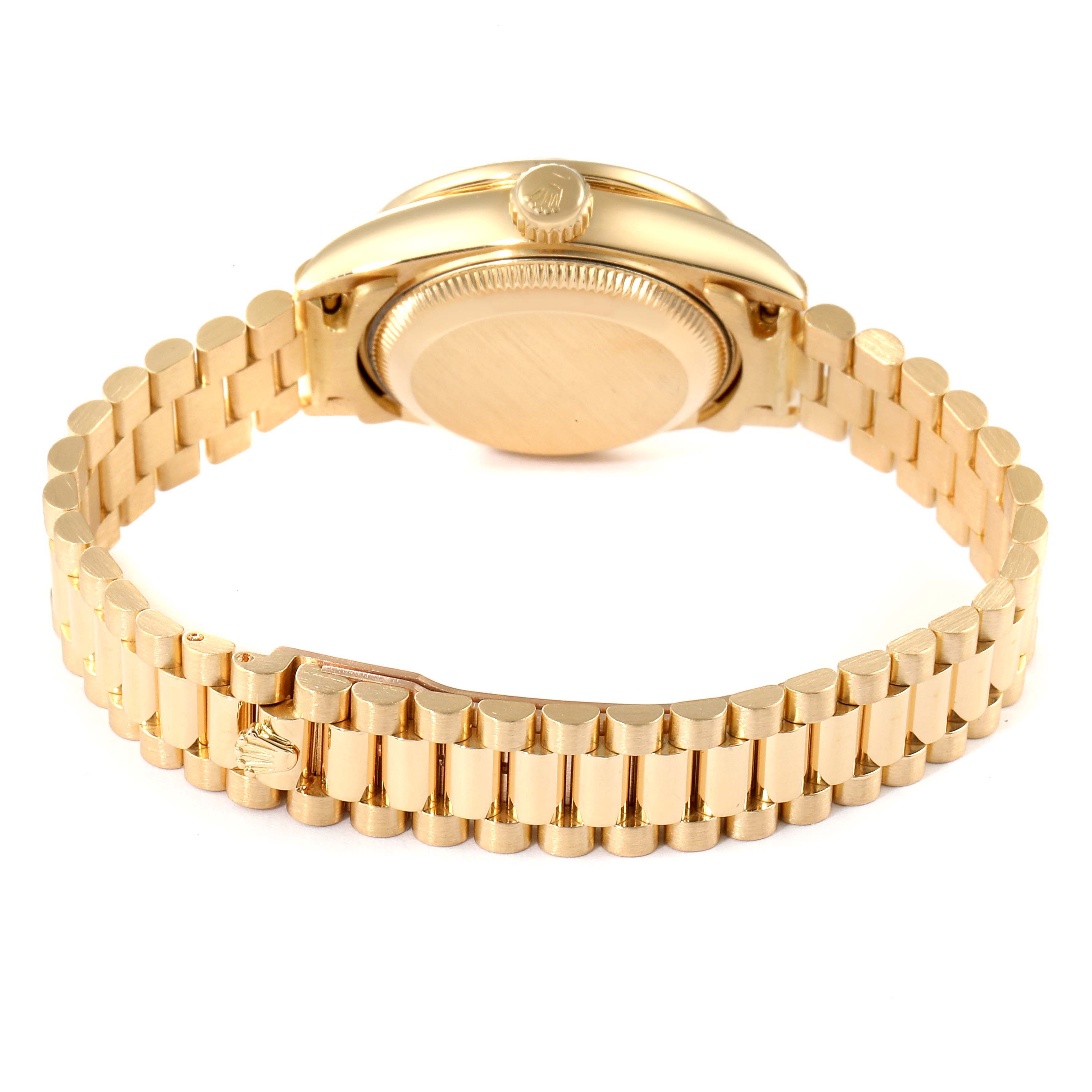 The image shows the back view of a gold Rolex President 69138 Women
s Yellow Gold White Dial 69138 Women
s Yellow Gold White Dial model watch, highlighting the case back, crown, and bracelet.