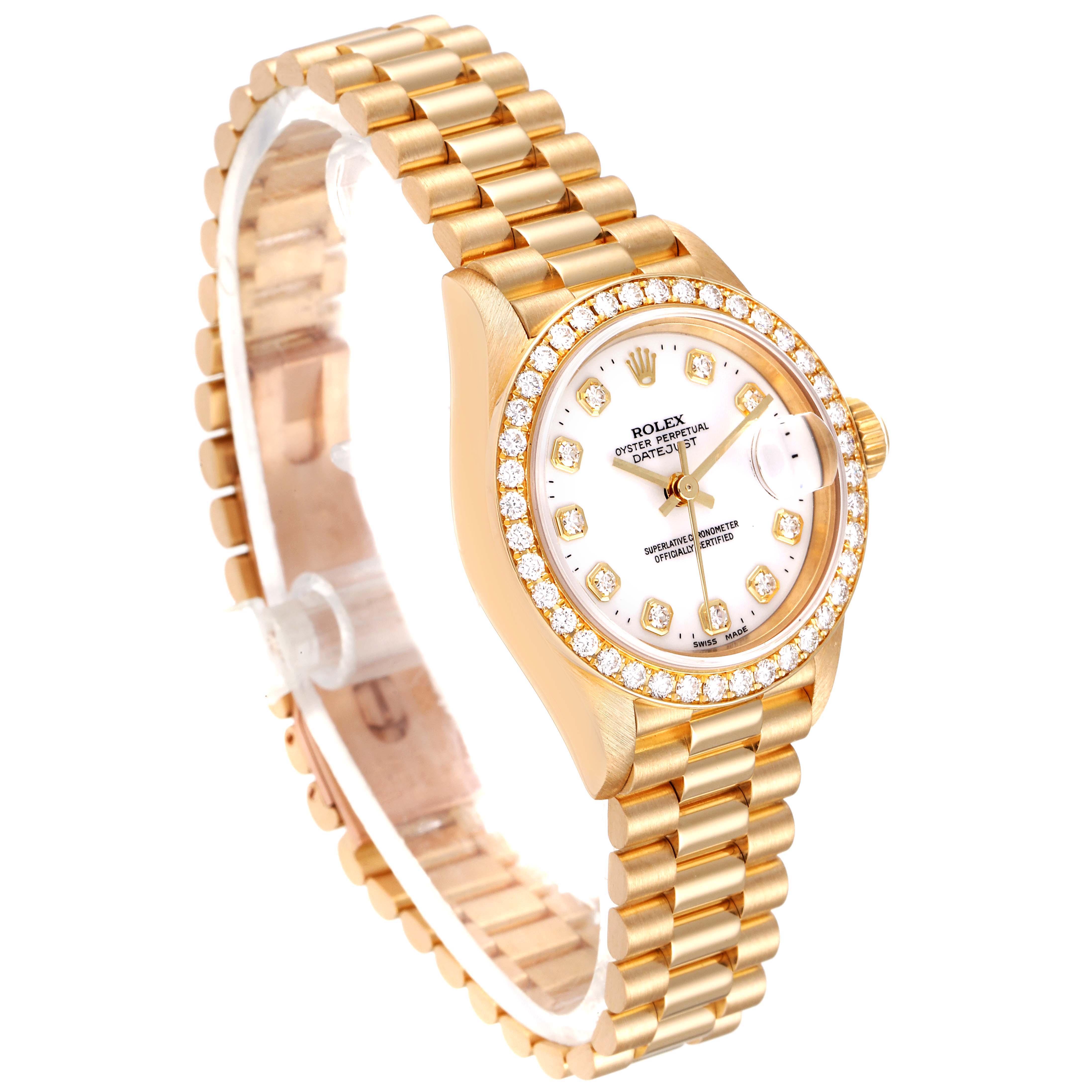 The image shows a Rolex President 69138 Women
s Yellow Gold White Dial 69138 Women
s Yellow Gold White Dial watch with a gold bracelet and diamond-studded bezel, viewed from an angled side perspective.