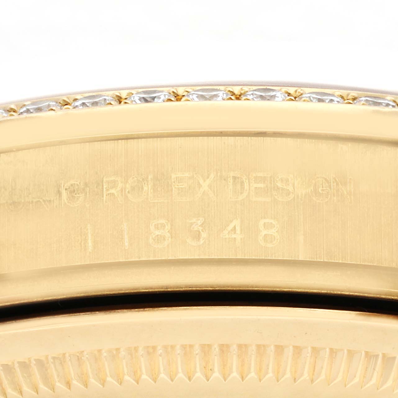 The image shows the engraved side of a Rolex President 118348 Men's Yellow Gold Champagne Dial 118348 Men's Yellow Gold Champagne Dial model with reference number details.