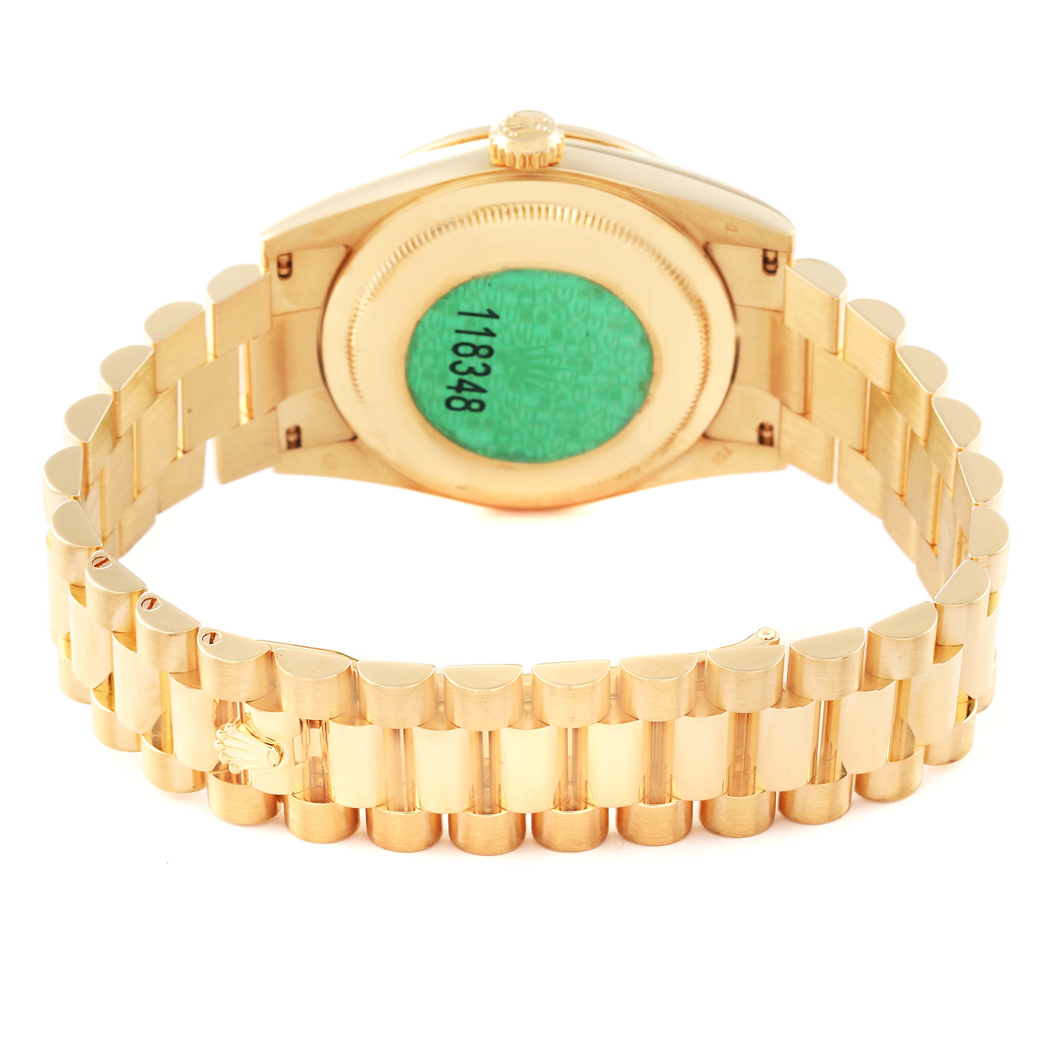 The image shows the back of a Rolex President 118348 Men's Yellow Gold Green Dial watch, highlighting its bracelet and case back with a sticker.